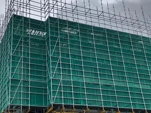Facade scaffolding fully wrapped in green safety netting