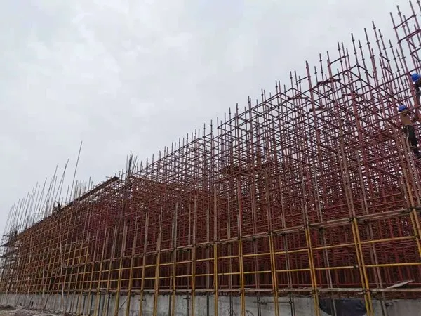 Painted shoring in red and yellow beside a structure under construction